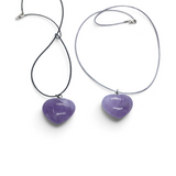 Rare Earth Gallery amethyst heart pendant necklaces on black and grey cords against a white background