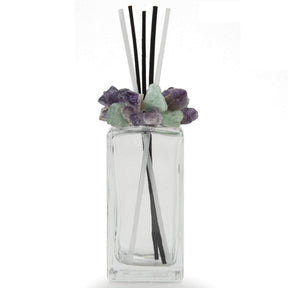 Crystal scent diffuser front view, clear bottle capped with green and purple fluorite and reeds