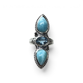 Rare Earth Gallery sterling silver ring with two pear larimar cabochons, oval blue topaz, and ornate star detailing.