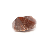 Auralite 23 complete point resting on its side, deep brick-red hematite bands under a polished glassy surface