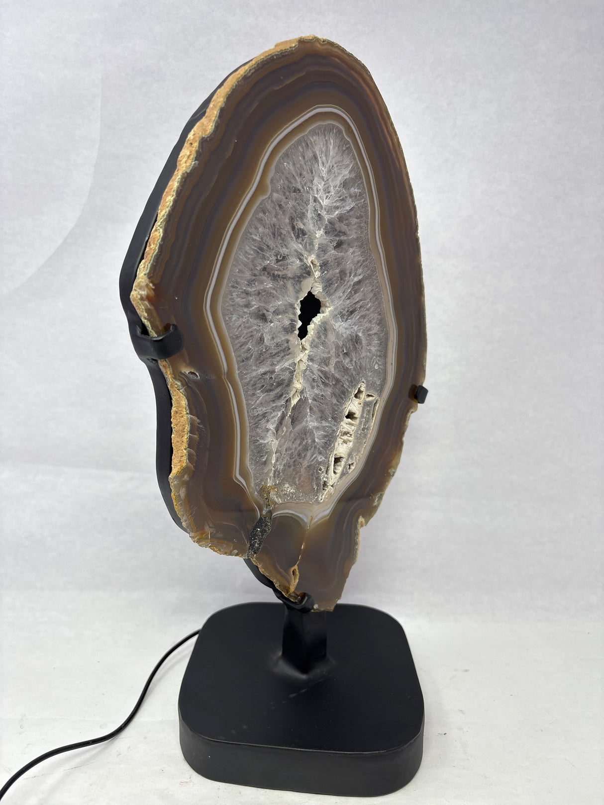 Chocolate Agate Slice with Amethyst Center On Illuminated Table Stand