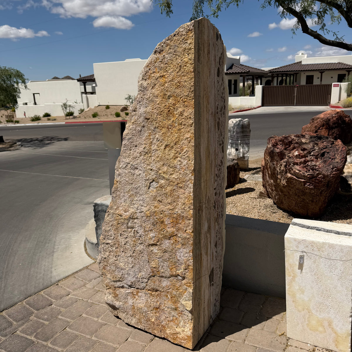 Side view of the ice onyx and caliche vertical fountain, golden caliche face and clast-studded edge, no basin