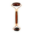 Red tiger's eye face roller with deep reddish-brown chatoyant bands on rose gold rollers, front view