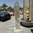 Zebra fossil onyx pillar fountain installed upright on a square base in the outdoor gallery stone yard