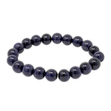 Blue goldstone 10 mm round beaded stretch bracelet with sparkling midnight-blue beads.
