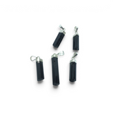 Rare Earth Gallery black tourmaline crystal pendants with silver cap bails arranged on a white background