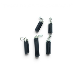 Rare Earth Gallery black tourmaline crystal pendants with silver cap bails arranged on a white background