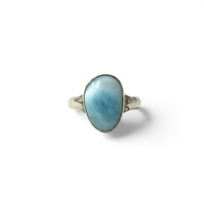 Rare Earth Gallery larimar ring featuring a small freeform blue cabochon stone set on a hammered silver band