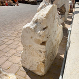 Corner-cut fossil onyx fountain slab seen from the side, showing its thickness and honey-toned banding