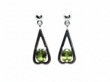 Rare Earth Gallery peridot dangle earrings featuring faceted oval stones in sterling silver reverse heart settings.