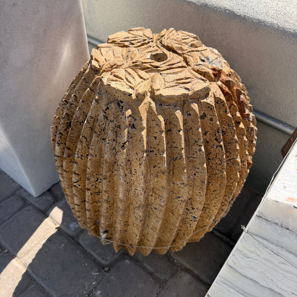 Red travertine barrel cactus carving fountain from above, carved crown with drilled center hole