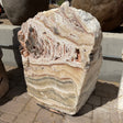 Sunset Fossil Onyx fountain block with cream and peach layers and fossil-filled cavities near the top