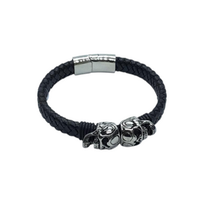 Rare Earth Gallery black braided leather bracelet featuring two stainless steel skull sliders and a magnetic lock.