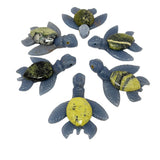 Serpentine and angelite sea turtle carvings arranged in a circle showing assorted green shell patterns