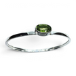 Rare Earth Gallery faceted peridot bracelet featuring an east-west set oval gemstone in a tall silver bezel setting.