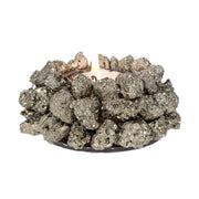 Peruvian Pyrite Tea Light Candle Holder with a lit flame amid raw golden pyrite nuggets around a glass cup