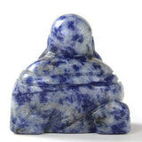 Sodalite Buddha carving seen from behind, blue-flecked stone showing topknot and draped robe