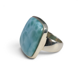 Larimar ring with rectangular cabochon in polished 925 silver bezel, angled front view of blue-green stone