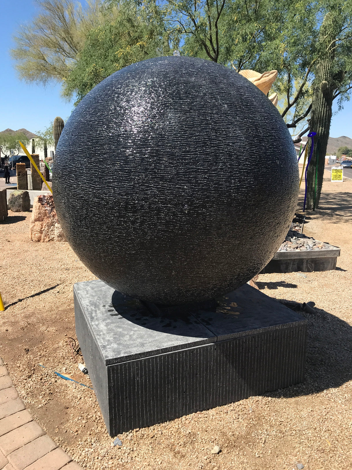 View of 60\" Diameter Black Casted Concrete Sphere Fountain - Extra Large