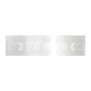 Translucent white selenite bar engraved with a row of moon phase symbols on a white backdrop