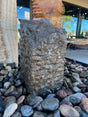 View of Dark Gray Chiseled Travertine Pillar With Tapered Top