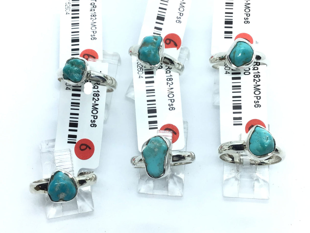 Polished freeform turquoise nugget rings in simple 925 sterling silver bezels and bands on display stands