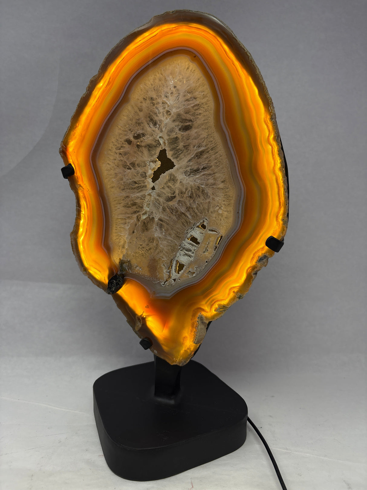 Chocolate Agate Slice with Amethyst Center On Illuminated Table Stand