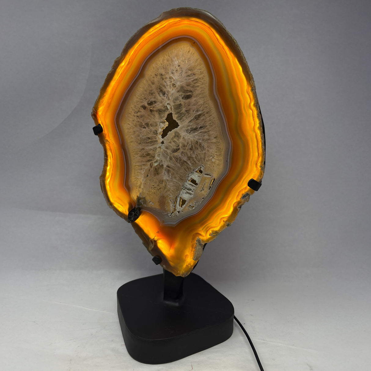 Chocolate Agate Slice with Amethyst Center On Illuminated Table Stand