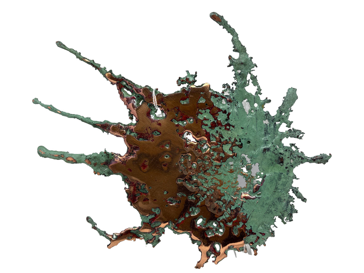 Star-shaped Michigan Splash Copper with bronze center and long green-patina spikes on a white backdrop