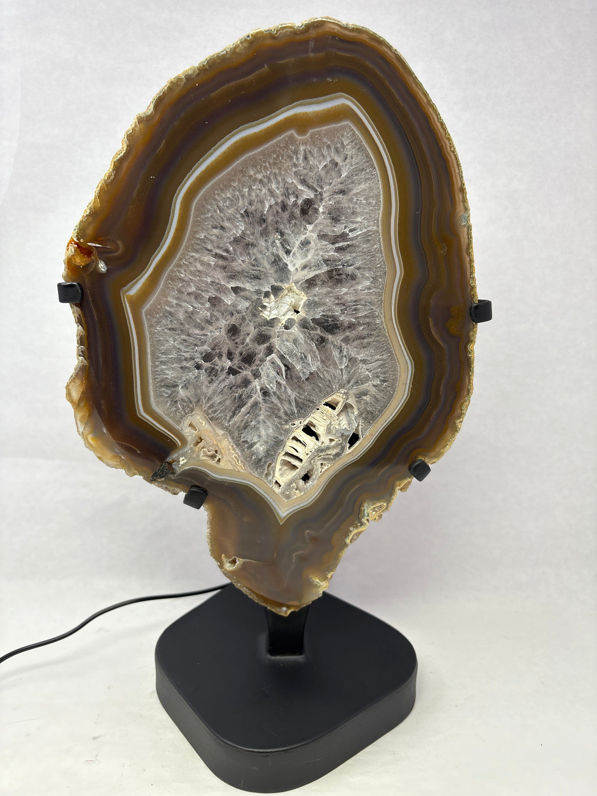 Chocolate Agate Slice with Amethyst Center On Illuminated Table Stand