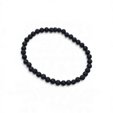 Rare Earth Gallery 4mm black lava stone bead bracelet with a textured, porous finish on a white background.