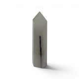 Black tourmaline in quartz crystal tower, milky white polished point with one slender dark tourmaline blade