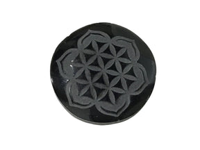 Obsidian cabochon featuring the Flower of Life design, showcasing intricate sacred geometry patterns.