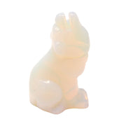 Opalite carved sitting wolf in milky white stone with a soft translucent glow