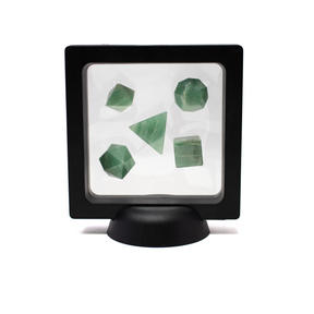 Set of green crystals in a black display case on a white background