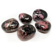 Five tumbled Rhodonite stones with rosy pink patches webbed by black manganese veining and high polish