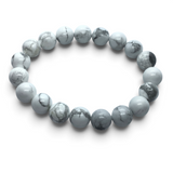 Rare Earth Gallery 10mm howlite beaded bracelet with natural white and grey marble-like veining on a white background.