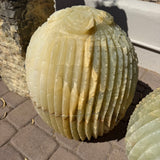 Rounded ribbed onyx cactus fountain with a single rose bloom at the crown