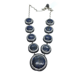 Graduated blue lapis lazuli cabochons haloed with marcasite and Swarovski crystal pave on silver chain