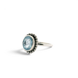 Faceted oval aquamarine bezel set in a beaded flower halo of simple 925 sterling silver