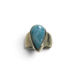 Rare Earth Gallery pear-shaped larimar cabochon ring with a raised bezel and wide silver band.