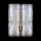 Rare Earth Gallery bookmatched Tehuacan Amber Onyx panels with symmetrical golden veining backlit for a glowing effect.