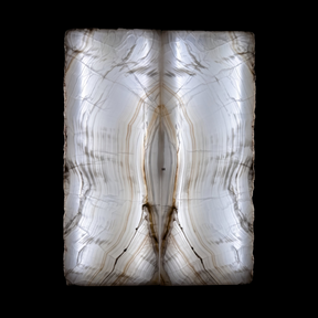 Rare Earth Gallery bookmatched Tehuacan Amber Onyx panels with symmetrical golden veining backlit for a glowing effect.