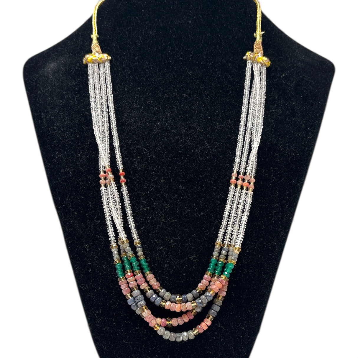 Multi corundum multi-strand beaded necklace with ruby, emerald, sapphire and clear quartz beads on a bust