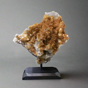 Crystal art on a black stand against a white background
