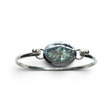 Rare Earth Gallery tension set labradorite bangle bracelet with a rough freeform teal stone and silver bezel edge