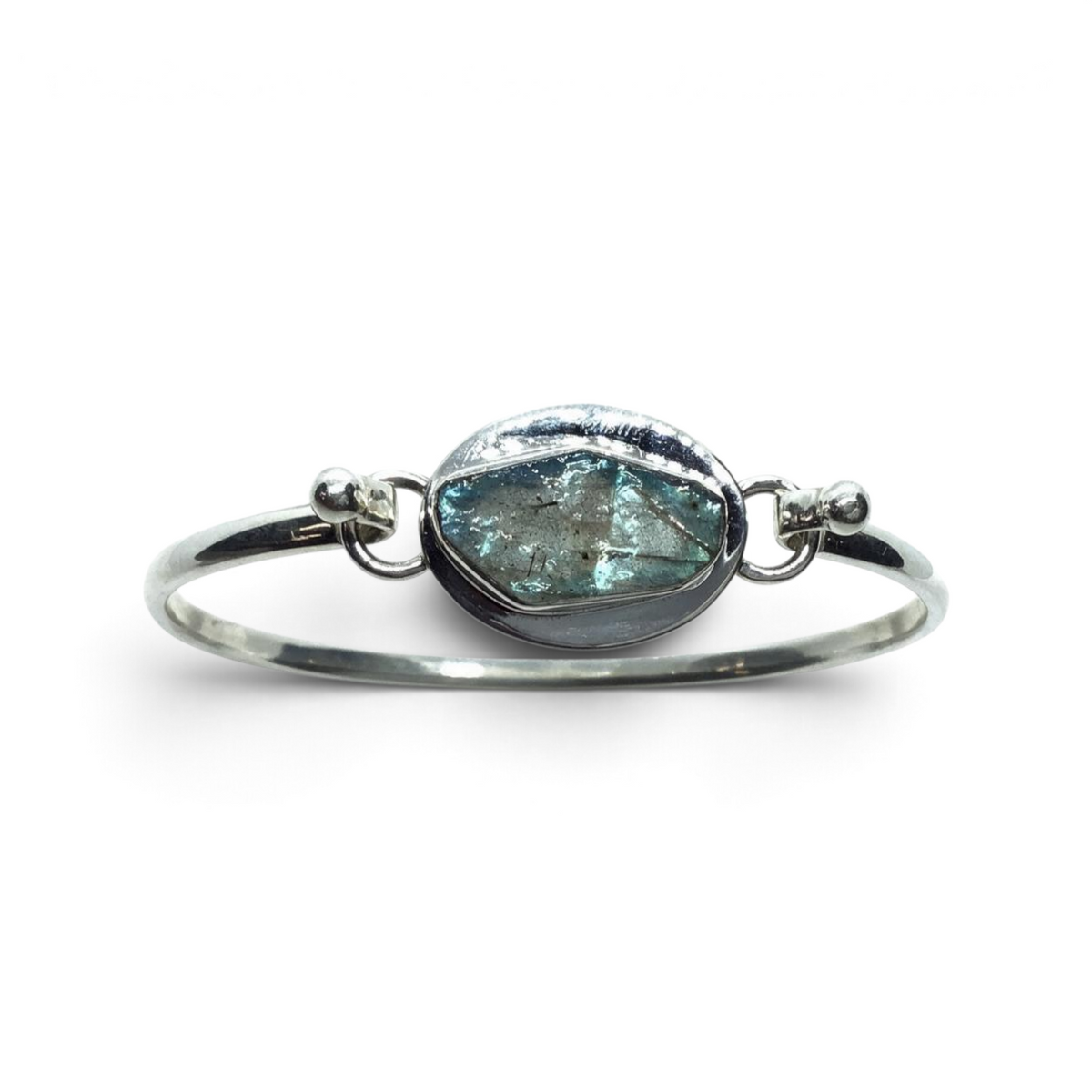 Rare Earth Gallery tension set labradorite bangle bracelet with a rough freeform teal stone and silver bezel edge