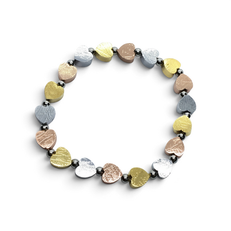 Rare Earth Gallery heart bracelet featuring Muonionalusta meteorite charms in rose gold, yellow gold, and silver tones.