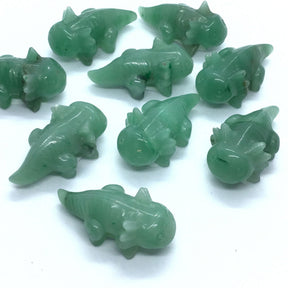 Aventurine axolotl carvings in green stone, several polished figures grouped on white