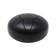 Matte black steel tongue drum, angled side view showing smooth domed profile and Flower of Life mark